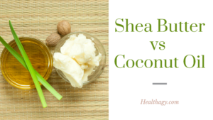 coconut oil in a small clear dish next to shea butter in a dish. Shea nuts lie beside the shea butter and green thin leaves accent the coconut oil