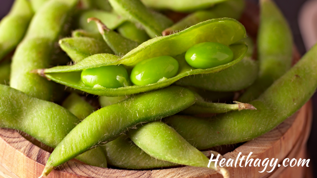 Green edamame pods. 3 green edamame beans inside of an edamame pod.