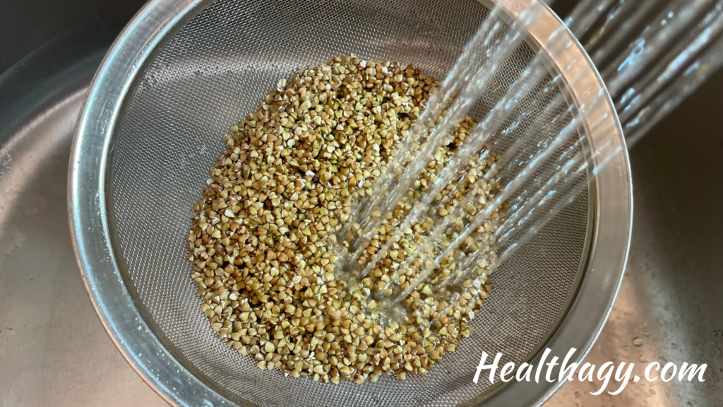 Water running though buckwheat groats in a strainer