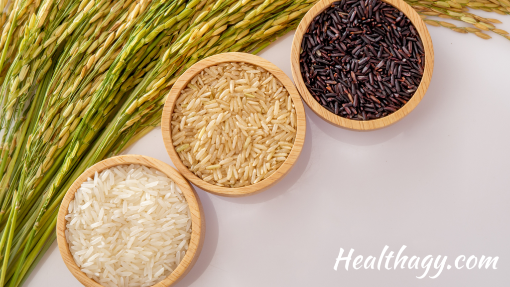 green rice culm, with 3 small bowls. One with white rice grains, one with brown rice grains and one with black rice grains