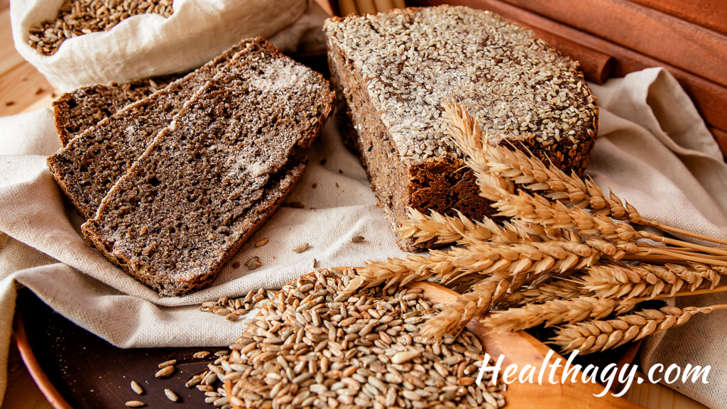 rye grains, rye bread and rye grass on a table 